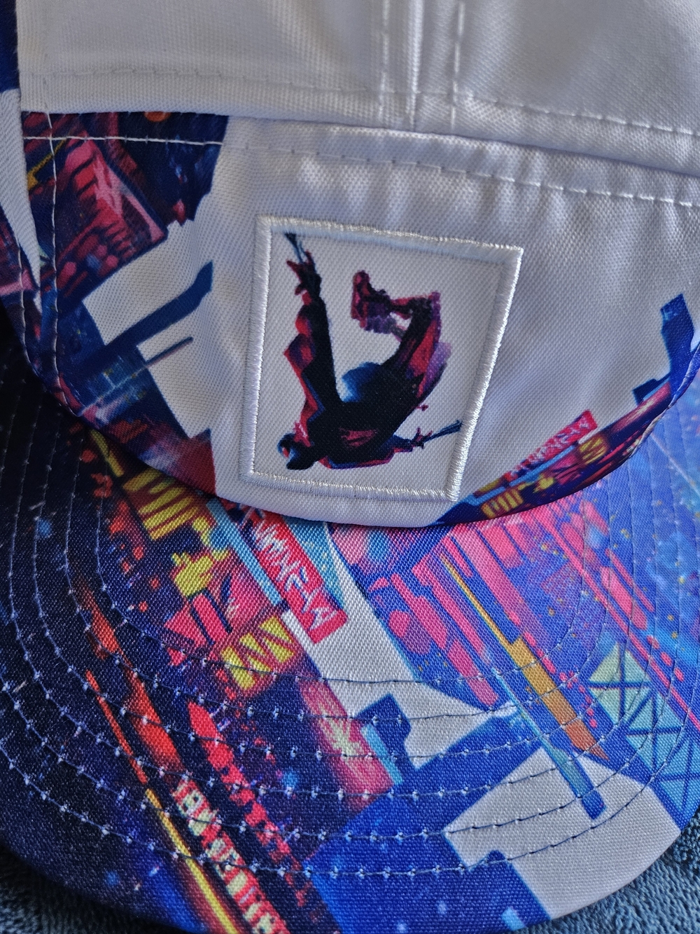 Disney Parks Spider-Man: Miles Morales artist series hat features a vibrant city